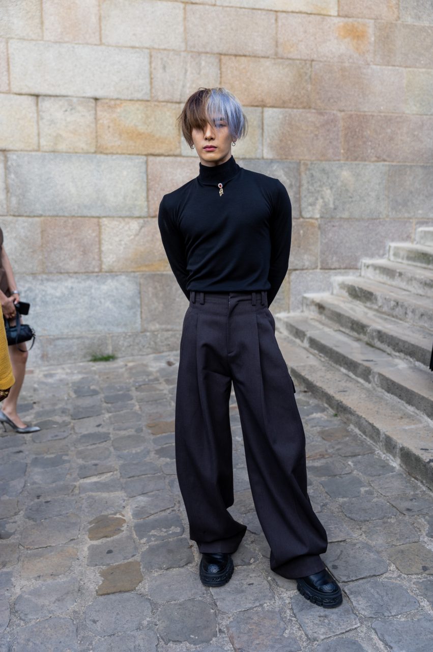 PARIS, FRANCE - JUNE 20: Jackson Wang wears black long shirt, grey flared pants outside Louis Vuitton during the Menswear Spring/Summer 2024 as part of Paris Fashion Week on June 20, 2023 in Paris, France. (Photo by Christian Vierig/Getty Images)